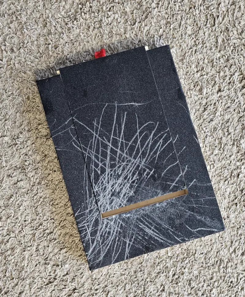 Dog nail scratch board with visible filing marks